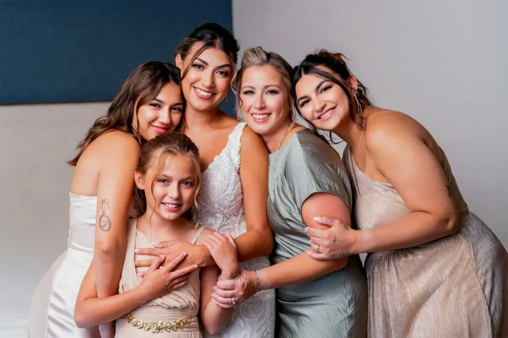 Bride and family group photo capturing love and smiles at San Diego wedding venue