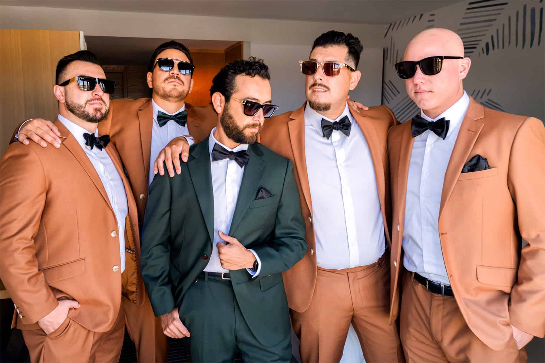 groom-groomsmen-wedding-style-san-diego Modern groomsmen in brown suits and groom in green tux ready for San Diego wedding day