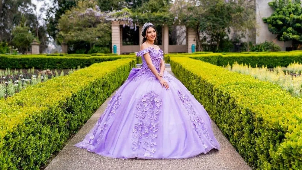 Quinceanera photography inspiration featuring a princess-style dress in Balboa Park gardens