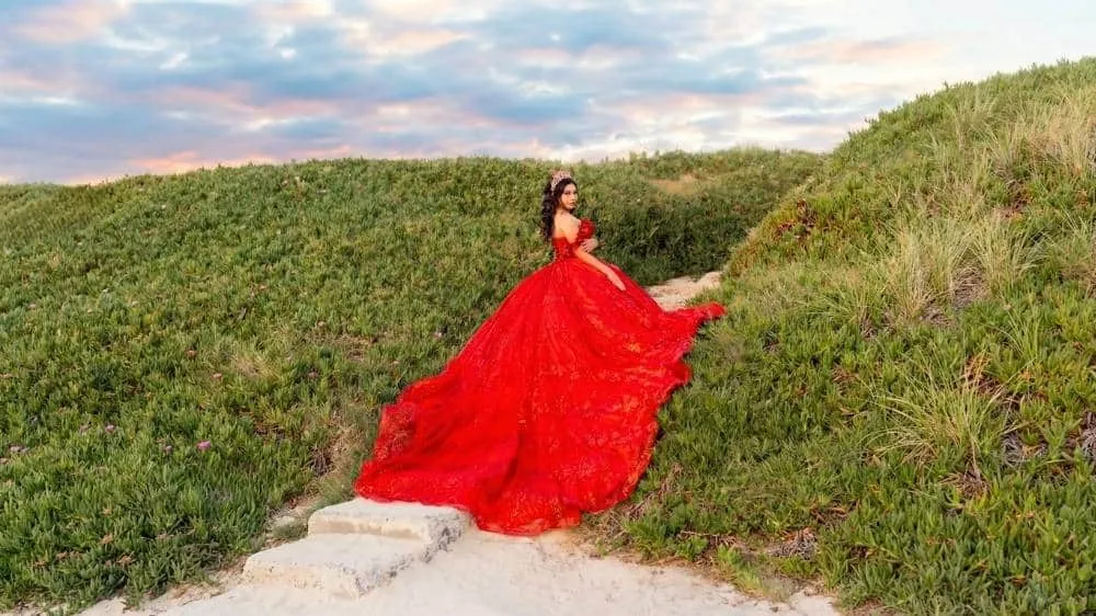 San Diego quinceanera photographer capturing a dramatic portrait in a flowing red dress