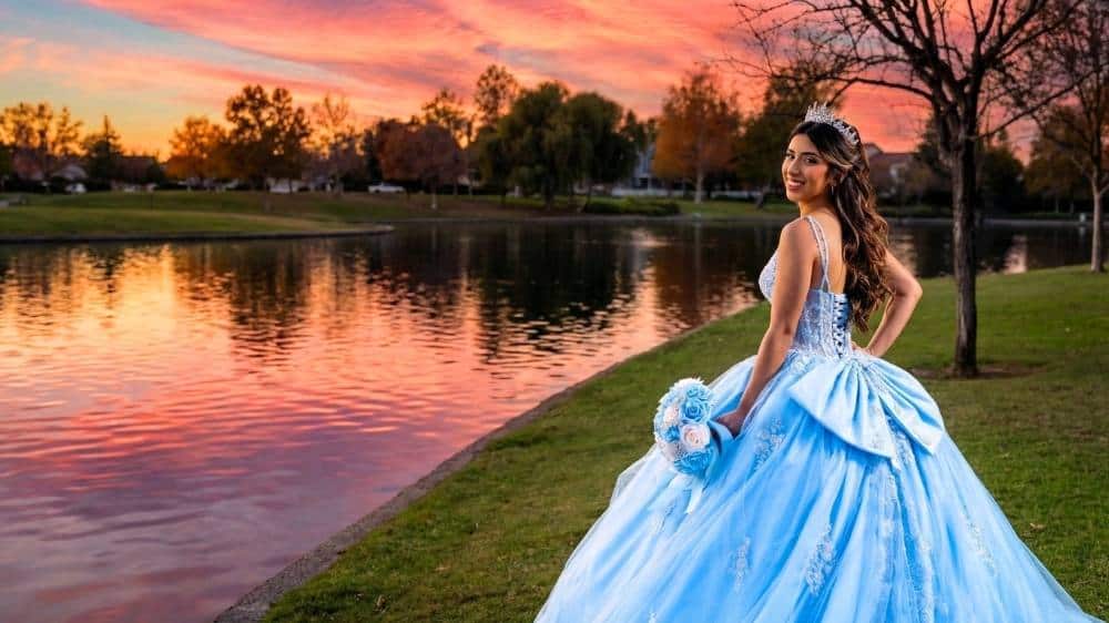 Quinceanera photography at Harveston Lake in Temecula capturing a sunset portrait in a blue dress