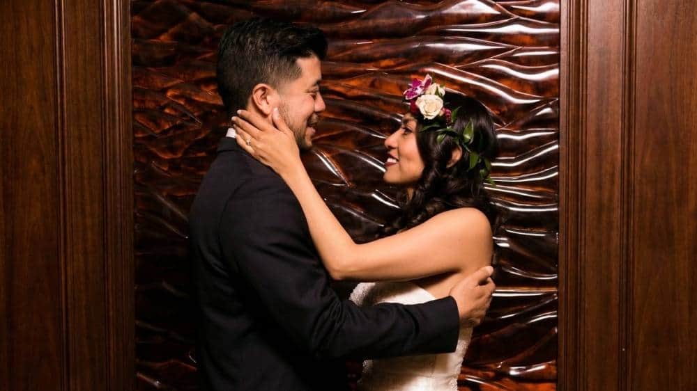 Wedding photographer documenting a loving embrace between bride and groom